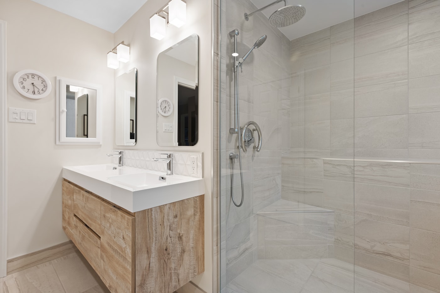 Glass shower beside a compact timber vanity